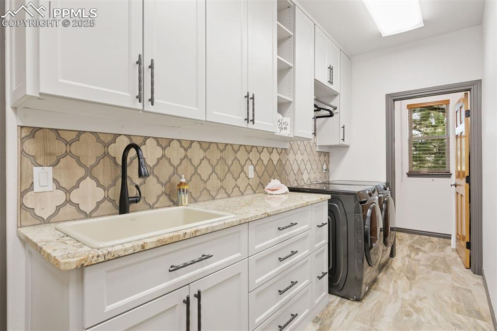 Image 32 of 50: Laundry room with smart storage solutions
