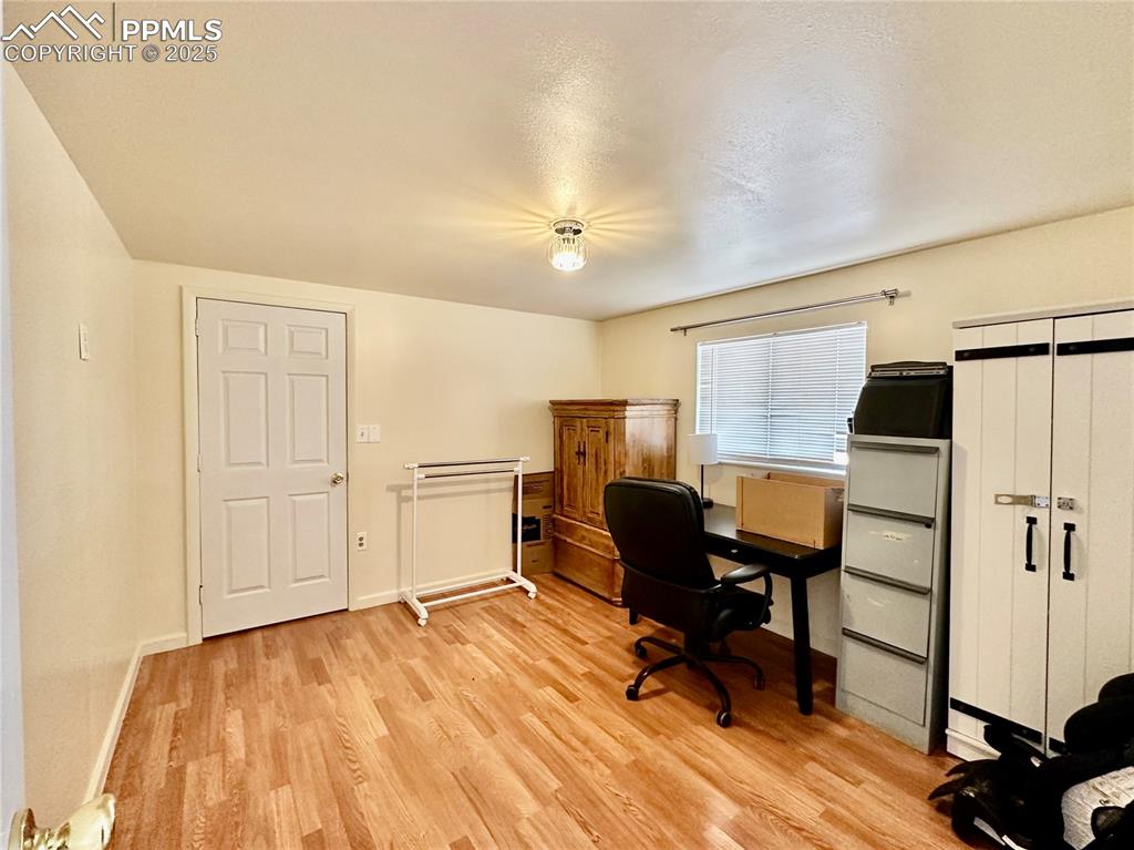 Image 10 of 20: Office space featuring light wood-style flooring and baseboards