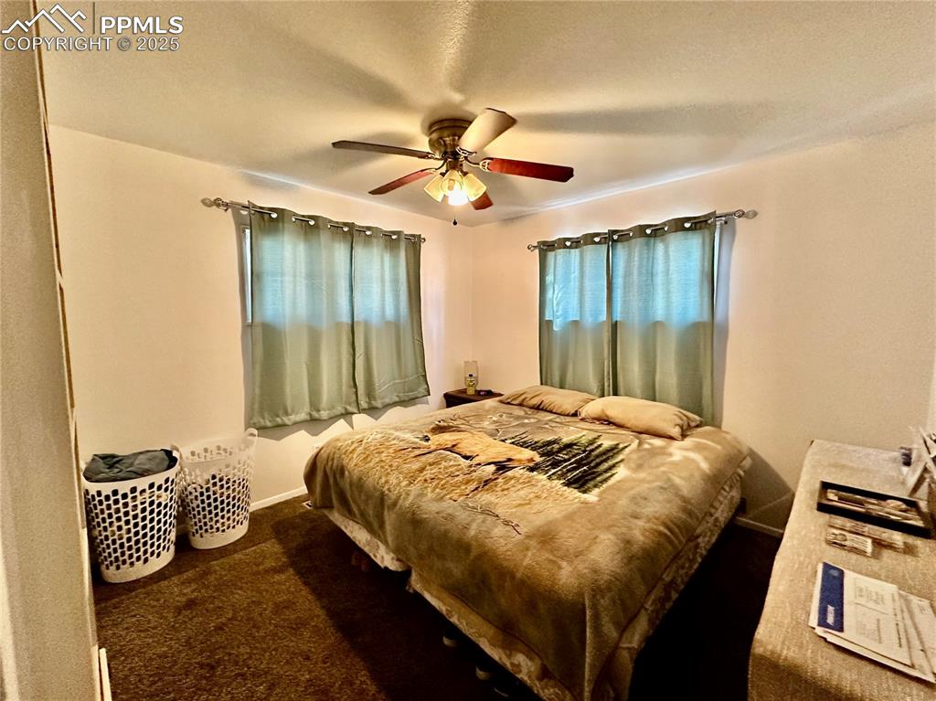 Image 12 of 20: Bedroom with carpet, a ceiling fan, and baseboards
