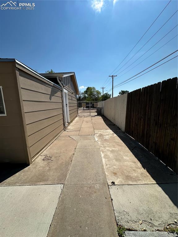 Image 17 of 20: View of side of property with fence