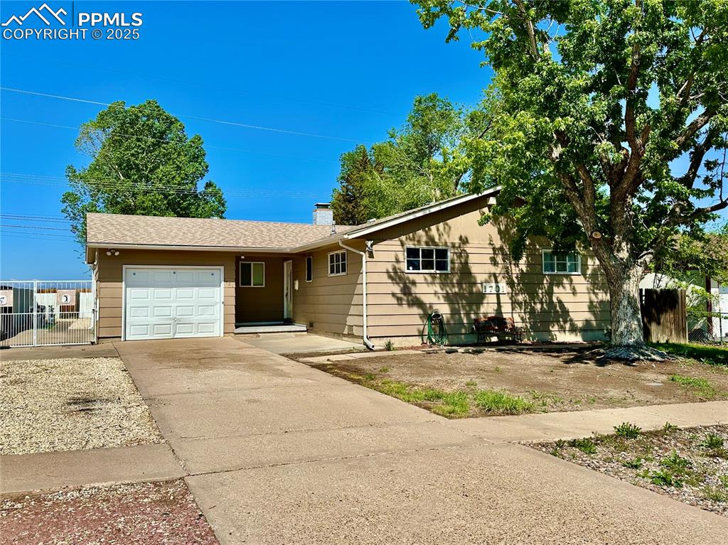 Image 2 of 20: Ranch-style house with an attached garage, concrete driveway, fence, and a 