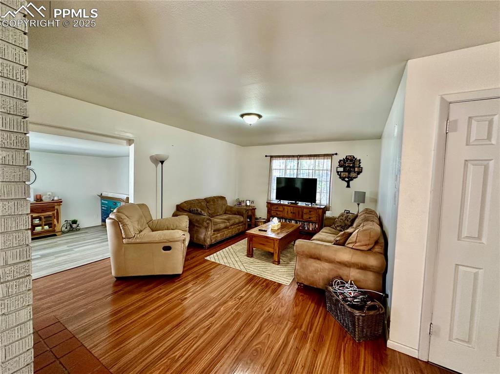 Image 3 of 20: Living room with wood finished floors