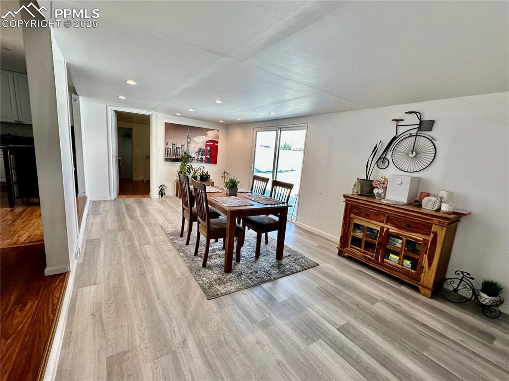 Image 9 of 20: Dining room featuring light wood-type flooring, recessed lighting, and base