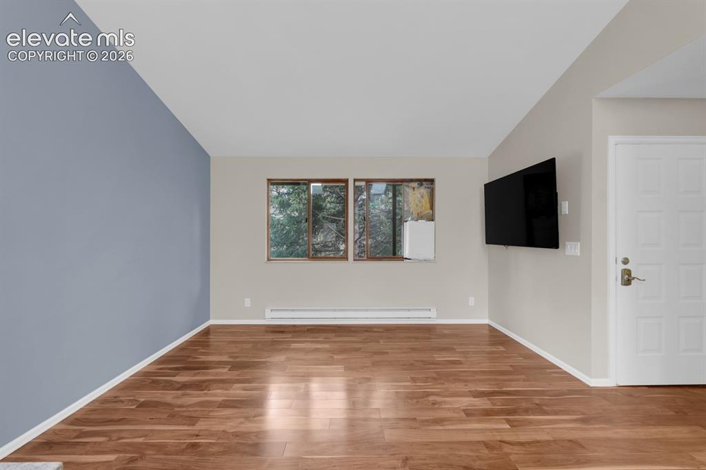 Image 8 of 32: Spacious living room with high ceilings 