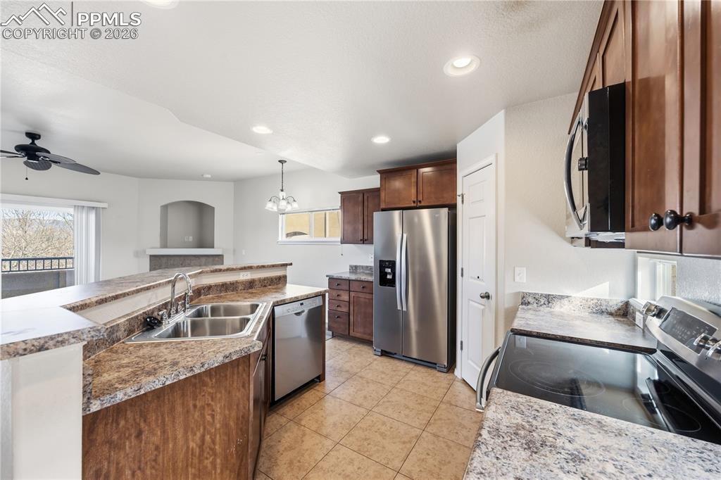 Image 11 of 30: Stainless steel appliances include a double sink, dishwasher, side by side 
