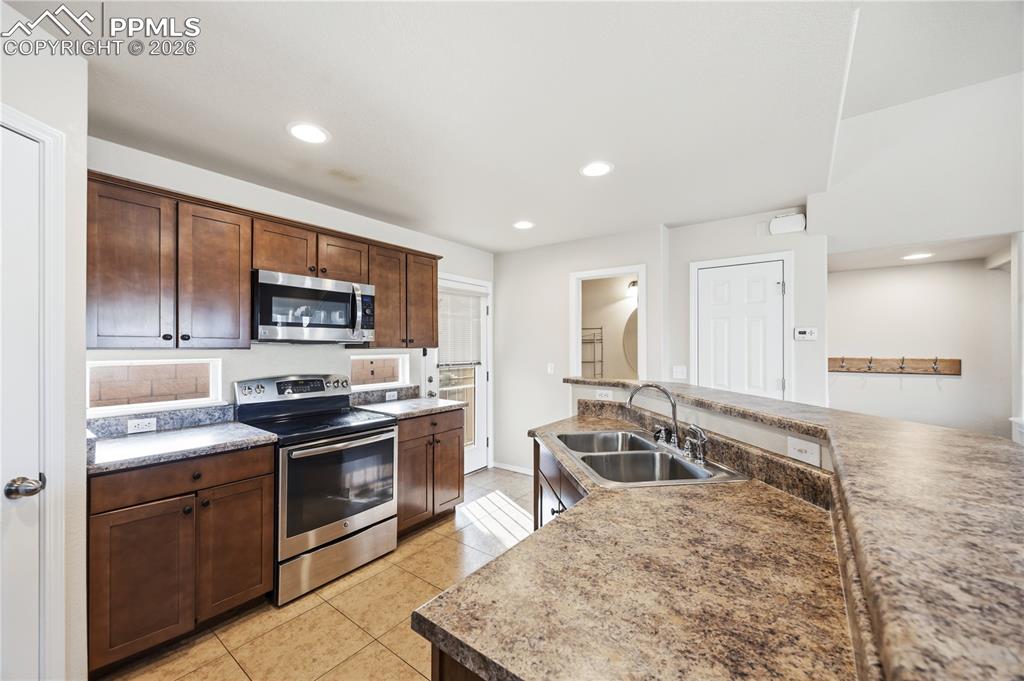 Image 12 of 30: Powder Bathroom and walk out to an enclosed patio from the Kitchen.