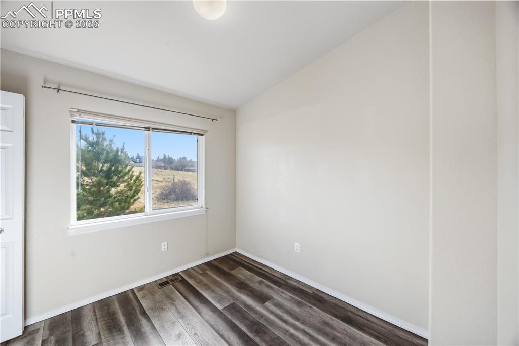 Image 15 of 30: Bedroom #1 offers a vaulted ceiling, LVP flooring, and vaulted ceiling.