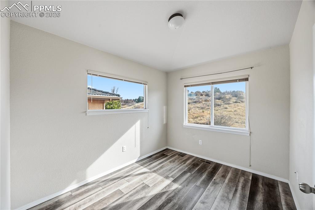 Image 17 of 30: Bedroom #2 has LVP floors, and view windows.
