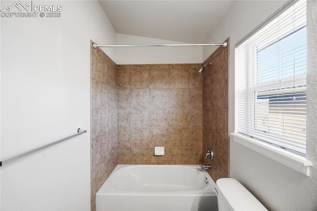 Image 20 of 30: Upper Level Full Hall Bathroom with tiled tub/shower.
