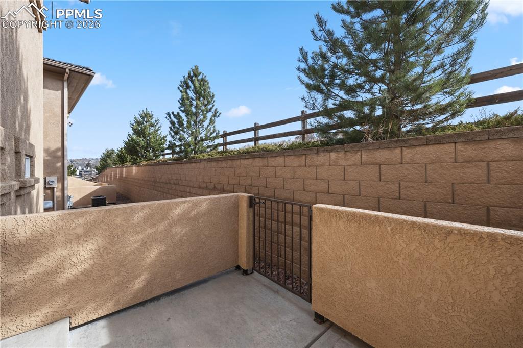 Image 27 of 30: Enclosed back patio for outdoor dining and relaxation.