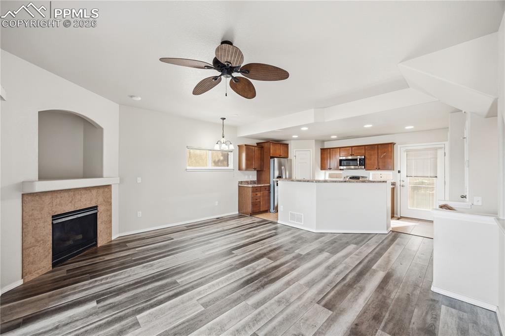 Image 8 of 30: The Living Room has a gas fireplace with tile surround to cozy up on on chi
