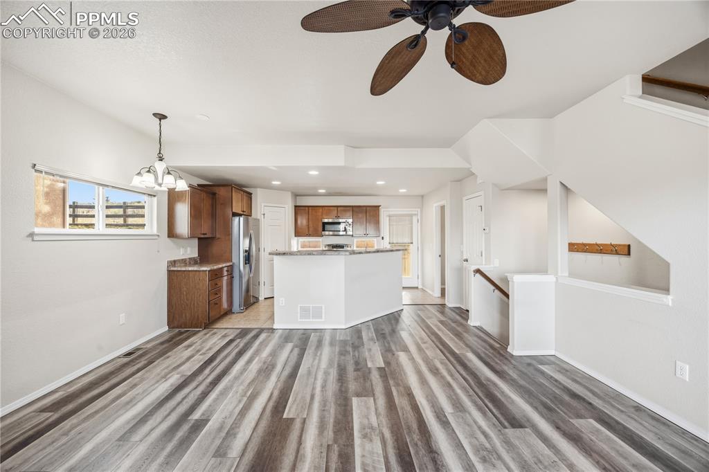 Image 9 of 30: View of the Dining Area and Kitchen from the Living Room.