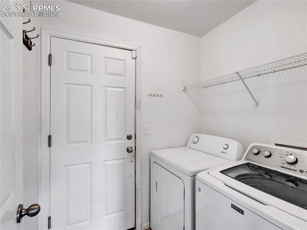 Image 10 of 23: Laundry area with washer and clothes dryer