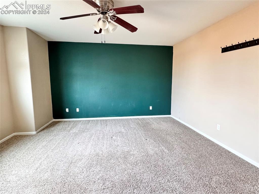 Image 14 of 23: Spare room with carpet and ceiling fan