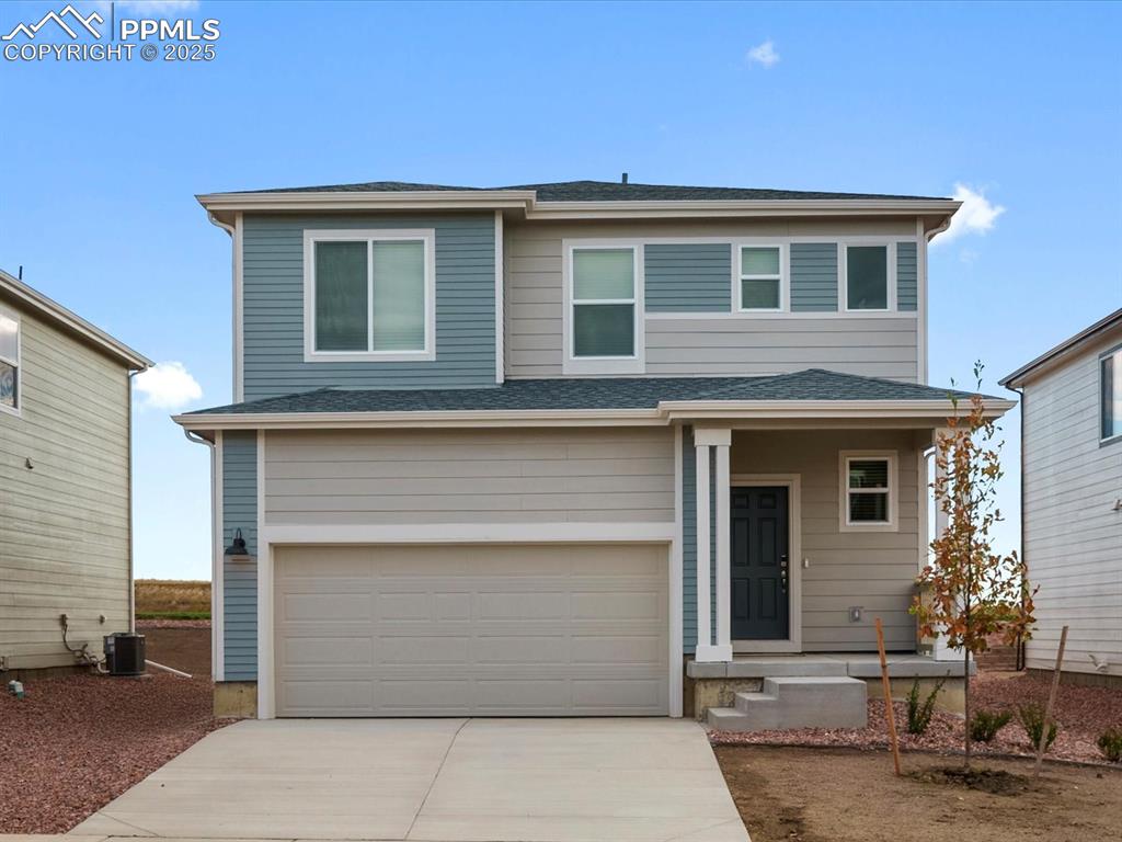 Image 1 of 23: View of front of property featuring an attached garage, a shingled roof, an