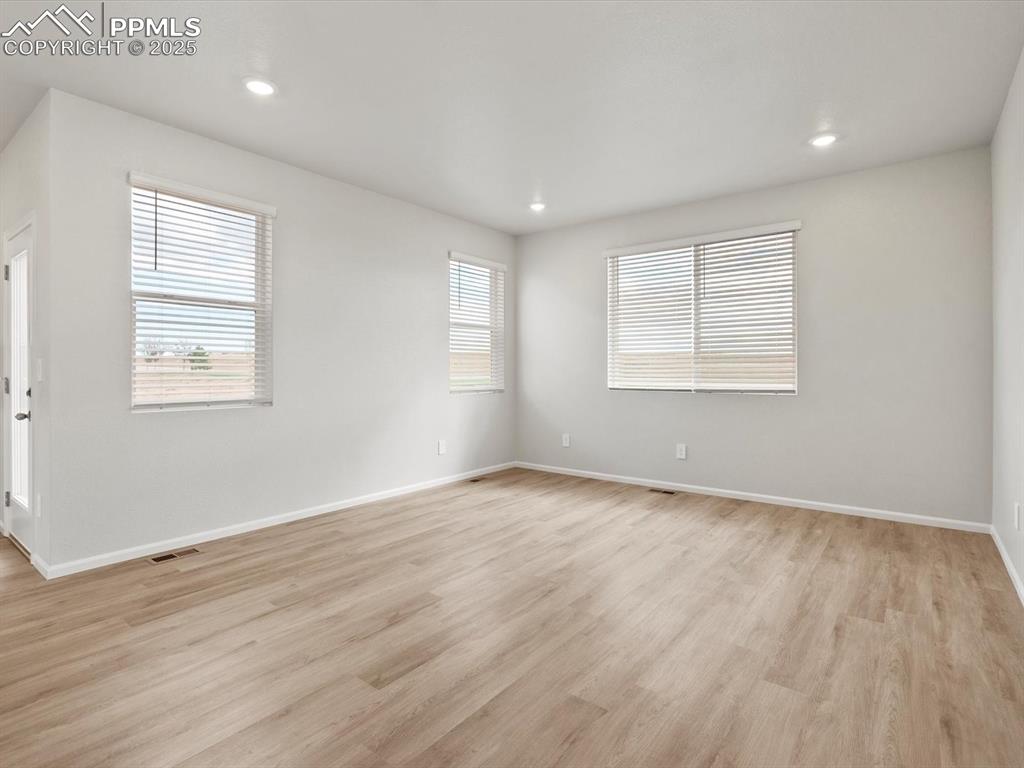 Image 11 of 23: Unfurnished room with light wood finished floors and recessed lighting
