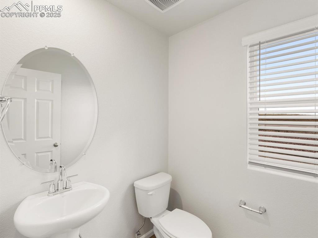 Image 13 of 23: Bathroom featuring a sink and toilet