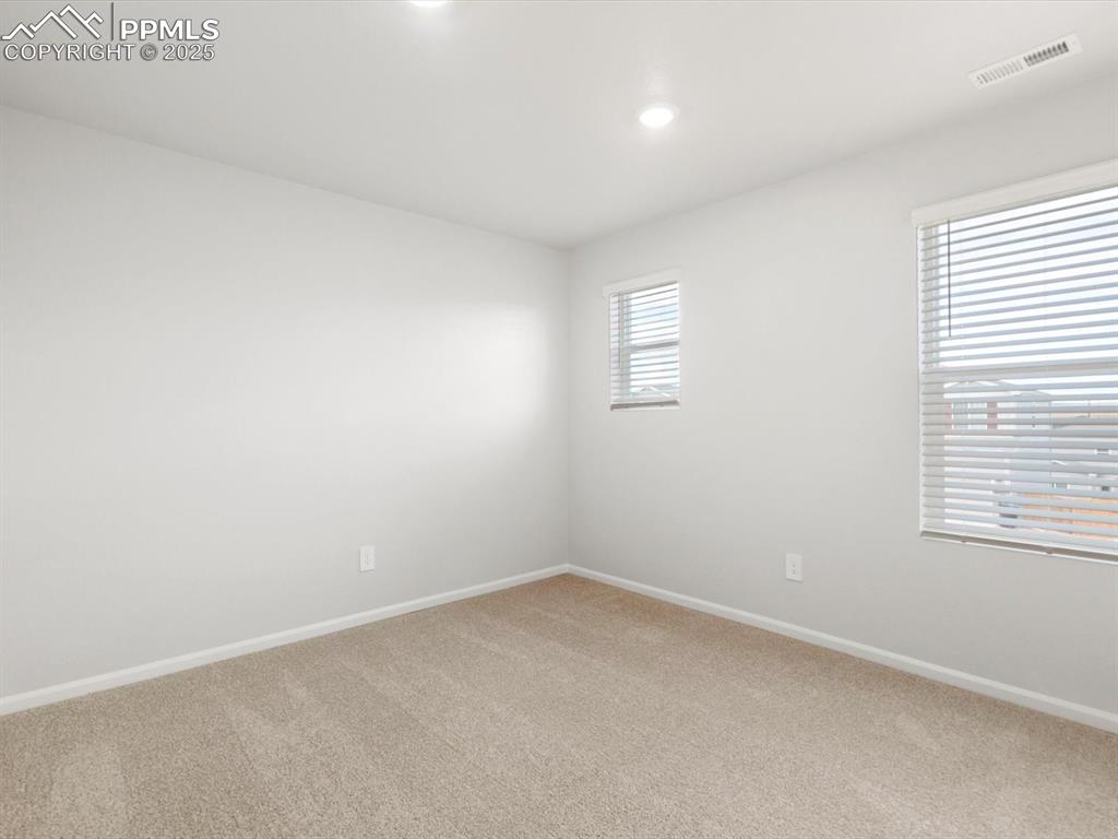 Image 14 of 23: Empty room with carpet and recessed lighting