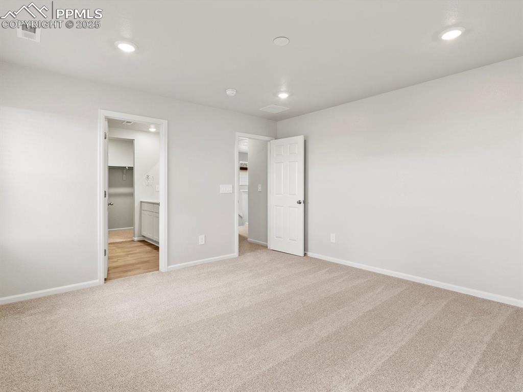 Image 19 of 23: Unfurnished bedroom featuring light colored carpet, recessed lighting, and 