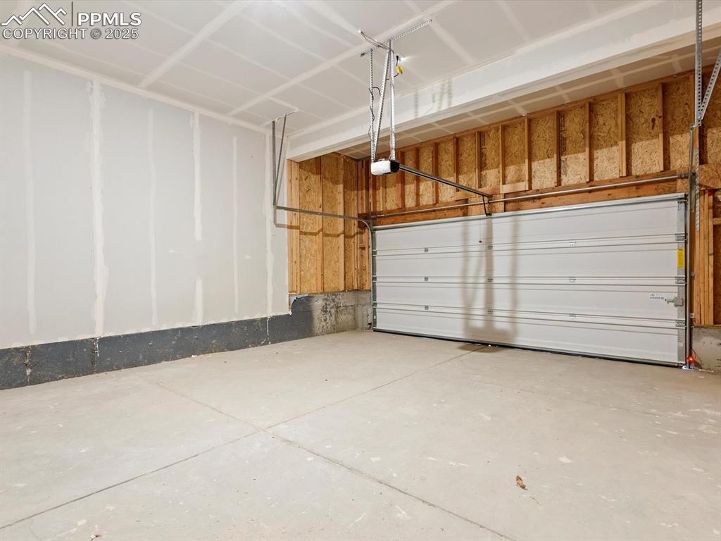 Image 23 of 23: Garage featuring a garage door opener