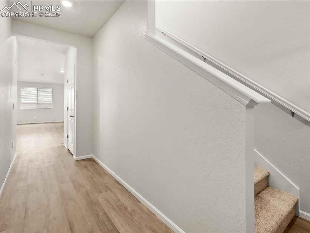 Image 8 of 23: Hall featuring light wood-style flooring, stairway, and recessed lighting