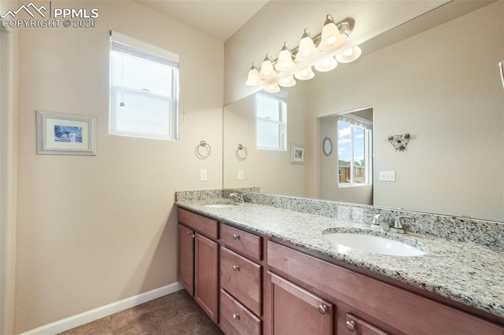Image 23 of 50: Bathroom vanity featuring a light-toned countertop with an integrated oval 