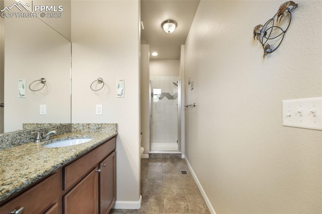 Image 25 of 50: Carpeted interior with neutral wall paint and a ceiling fan with light fixt