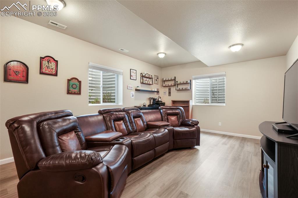 Image 28 of 50: Bathroom vanity with a granite-look countertop, integrated white oval sink,
