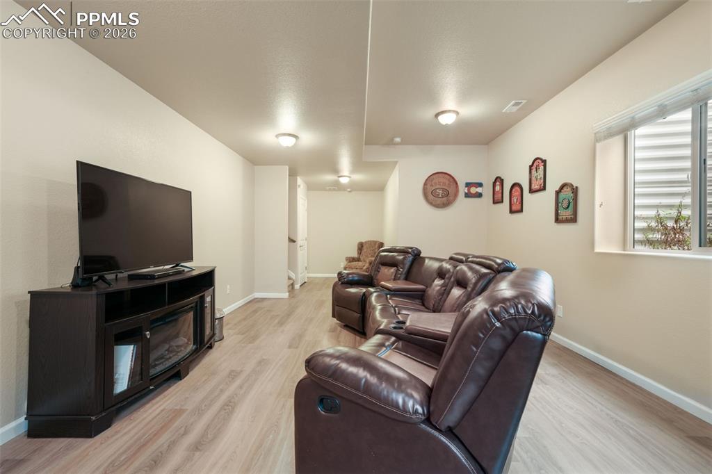 Image 29 of 50: Carpeted bedroom featuring a ceiling fan with integrated lighting, a large 