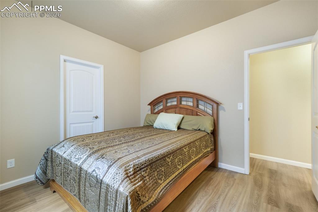 Image 31 of 50: Spacious entertainment area featuring light wood-finish flooring, recessed 