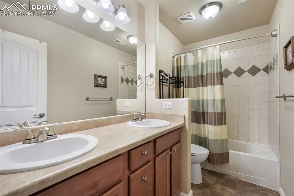 Image 34 of 50: Bedroom featuring light-toned wood-finish flooring, neutral wall paint, and