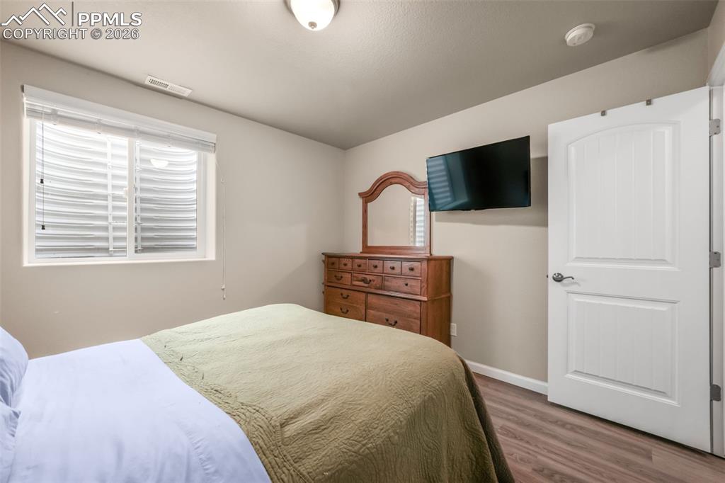 Image 36 of 50: Neutral wall color with wood-finish flooring
