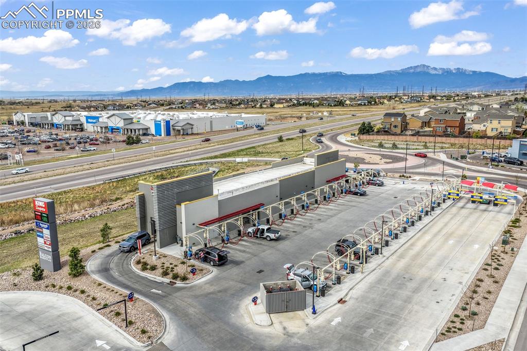 Image 45 of 50: Expansive backyard featuring a lush green lawn, a wooden privacy fence, and