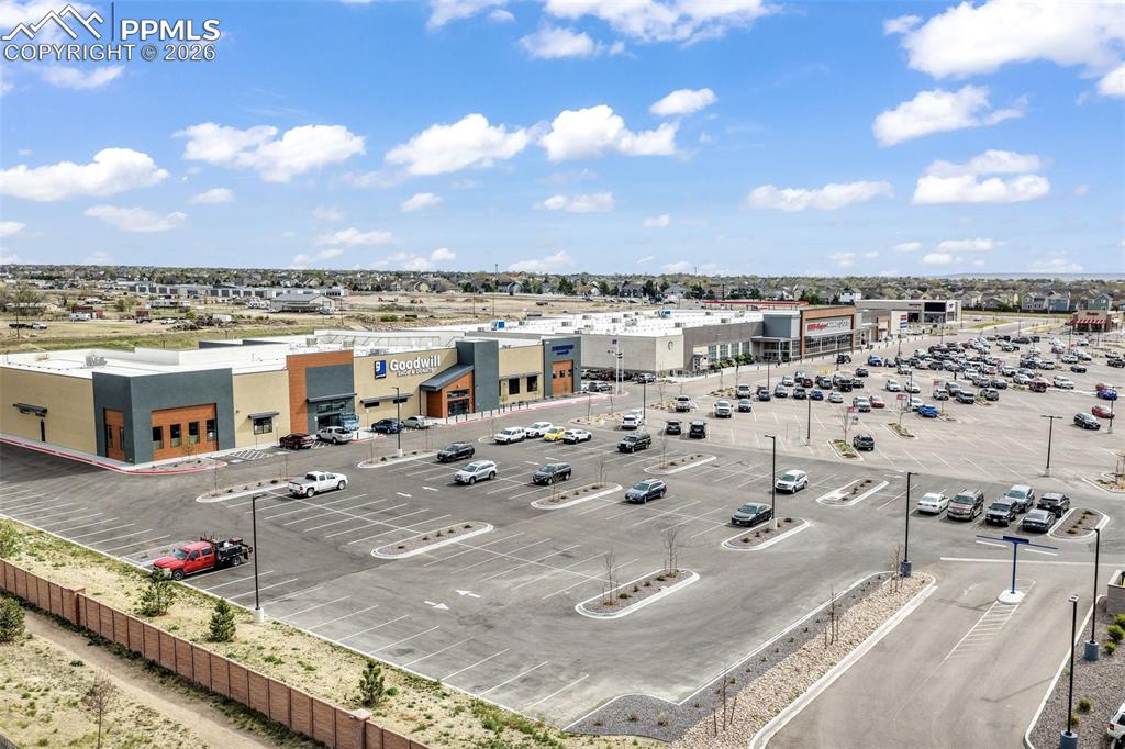 Image 47 of 50: Private backyard featuring a fenced perimeter, artificial turf lawn, concre