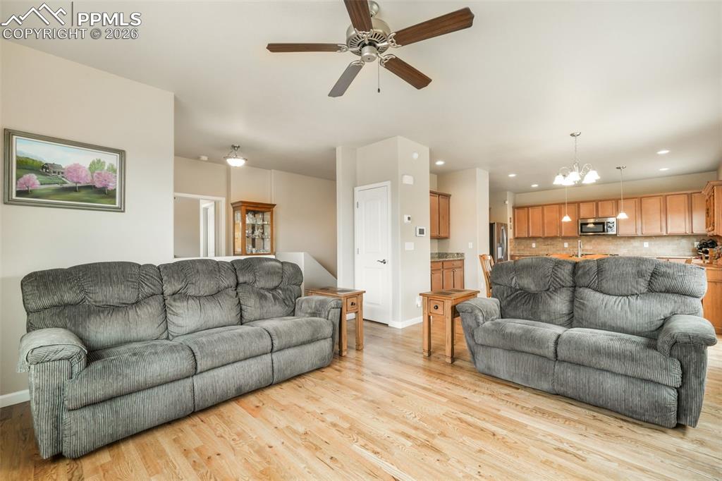 Image 7 of 50: Stucco exterior with stone veneer accents, concrete walkway, front porch en