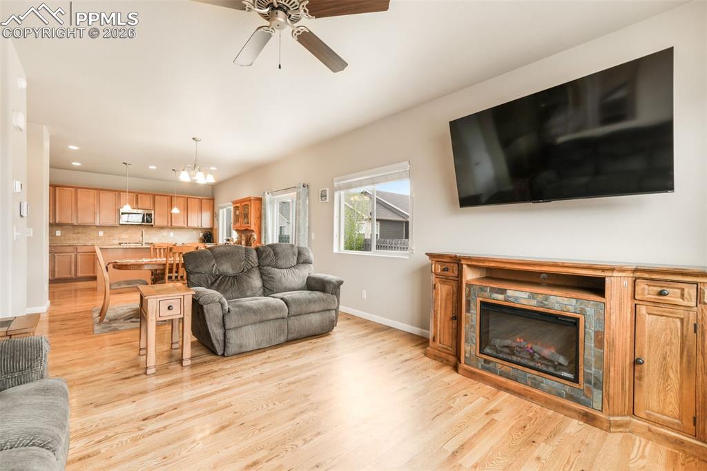 Image 9 of 50: Wood-finish flooring throughout, featuring a staircase with a wooden handra