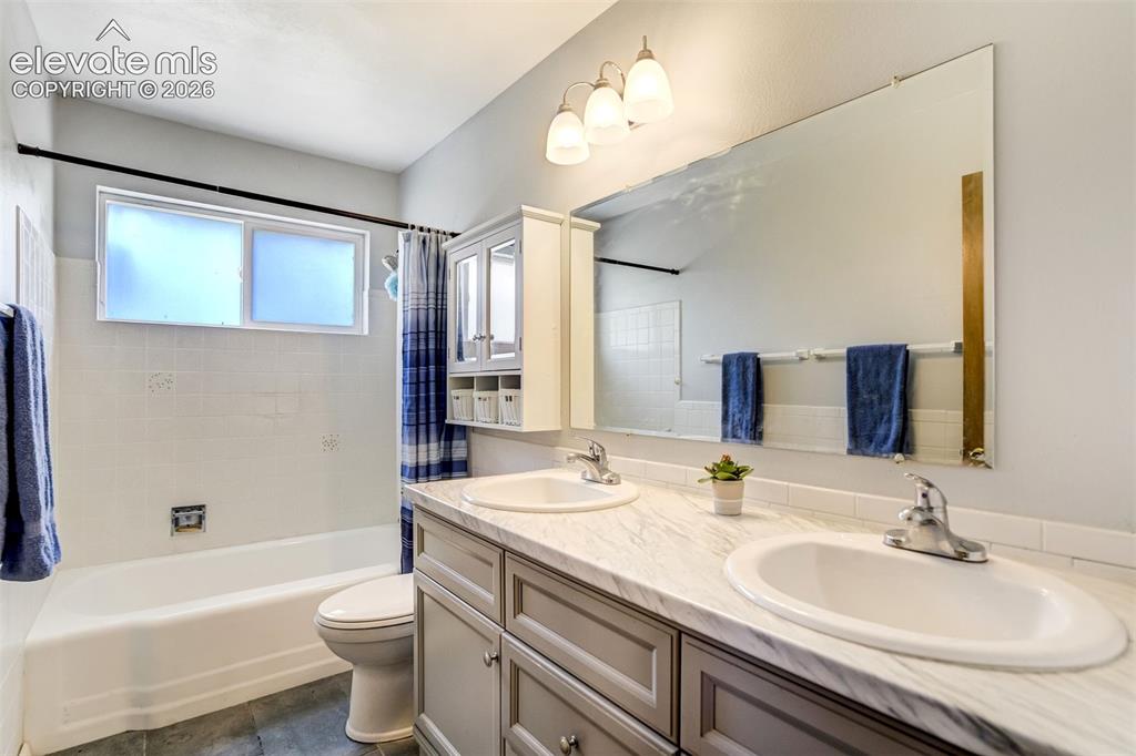 Image 27 of 45: Updated dual vanity main level bath.