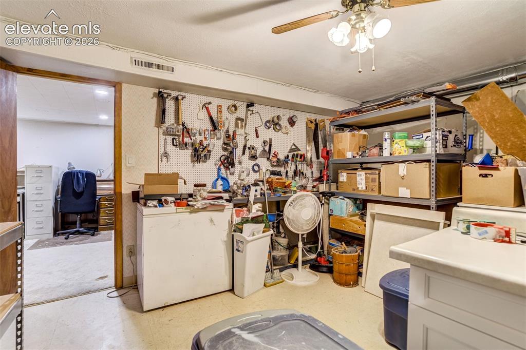 Image 35 of 45: Non-conforming basement bedroom, currently used for storage/workshop.
