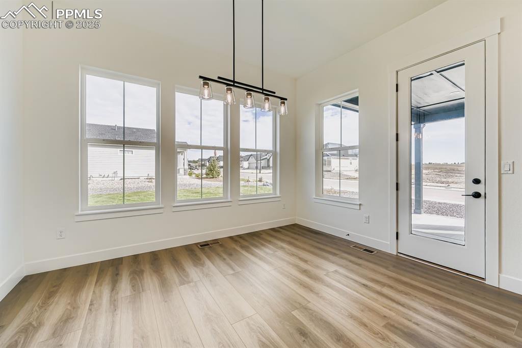 Image 11 of 27: Unfurnished dining area featuring light wood-style floors and baseboards