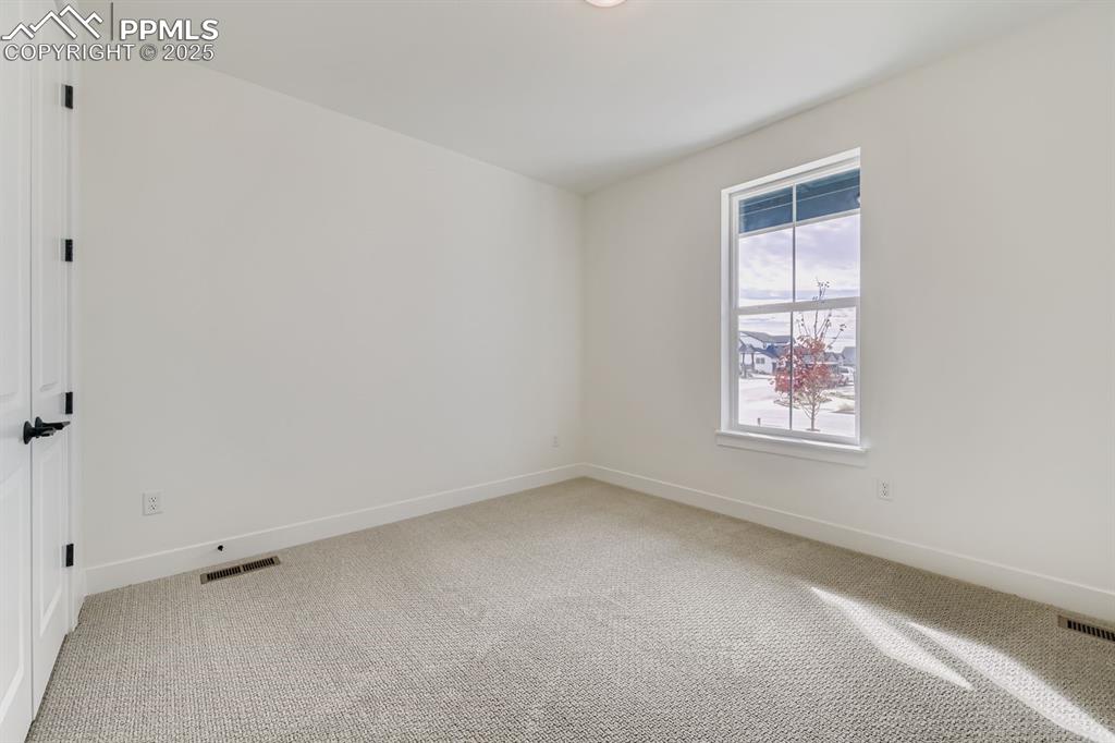 Image 17 of 27: Unfurnished room featuring light carpet