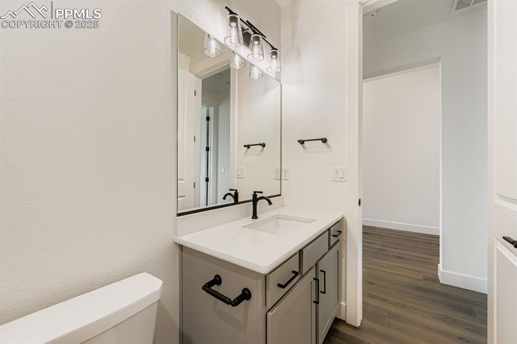 Image 18 of 27: Bathroom with vanity and dark wood finished floors