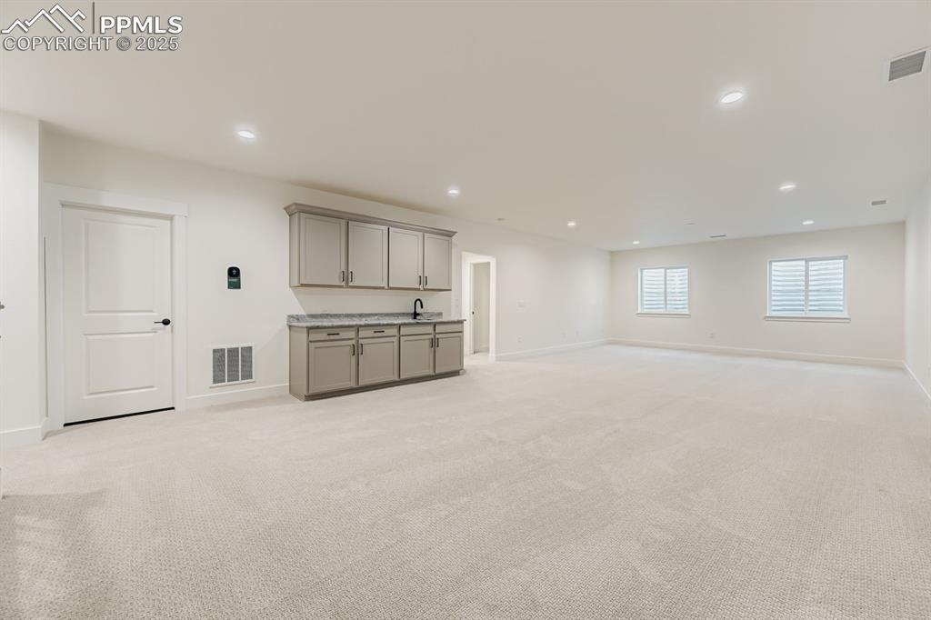 Image 20 of 27: Below grade area featuring light carpet and recessed lighting