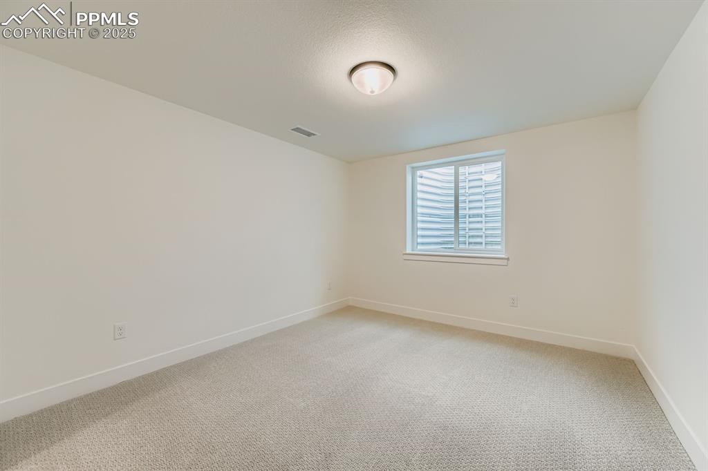 Image 23 of 27: Spare room with light colored carpet and baseboards