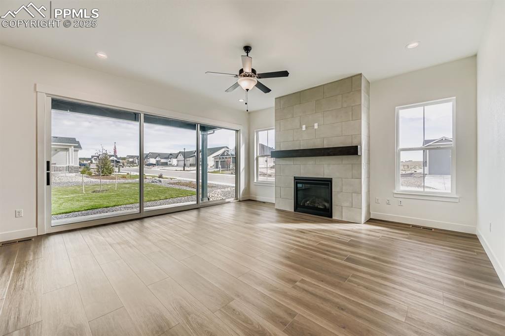 Image 5 of 27: Unfurnished living room featuring light wood-type flooring, a fireplace, a