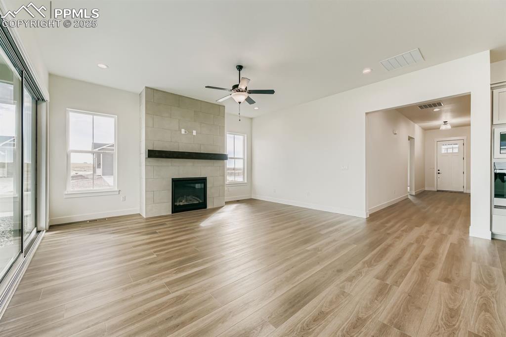 Image 6 of 27: Unfurnished living room featuring healthy amount of natural light, ceiling