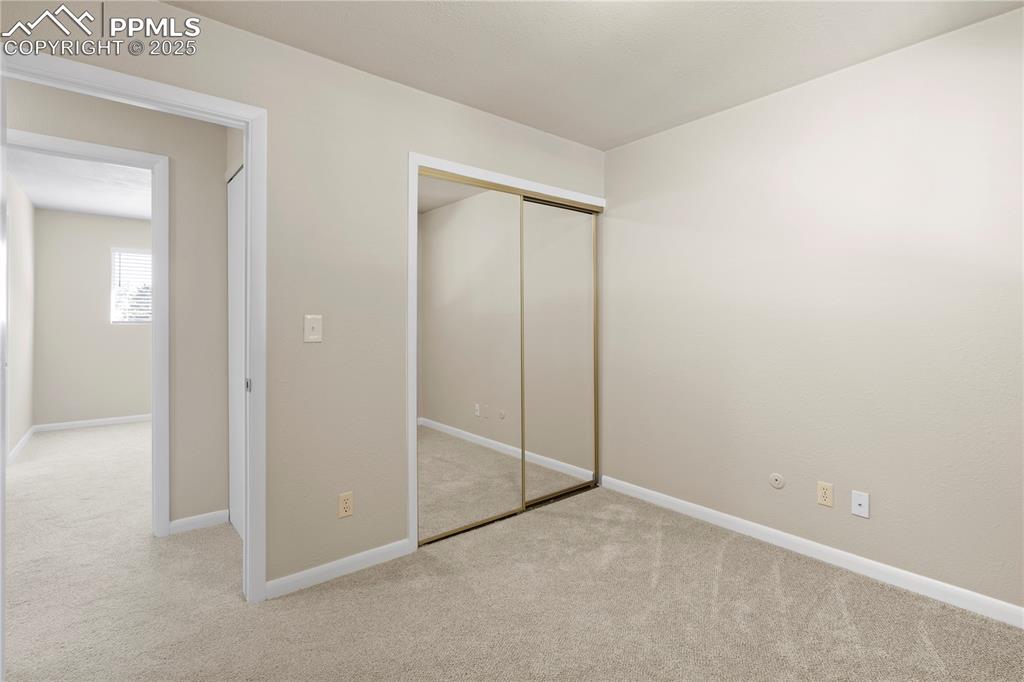 Image 12 of 35: Unfurnished bedroom featuring light carpet and a closet