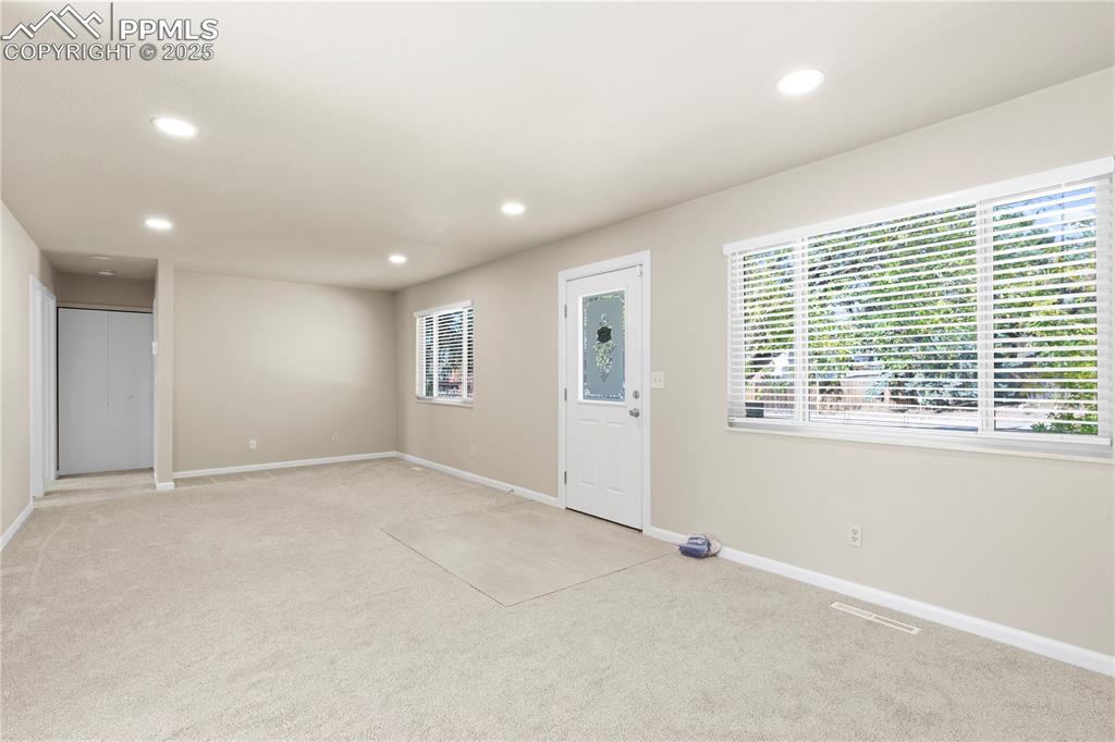 Image 15 of 35: Entrance foyer with recessed lighting and light carpet