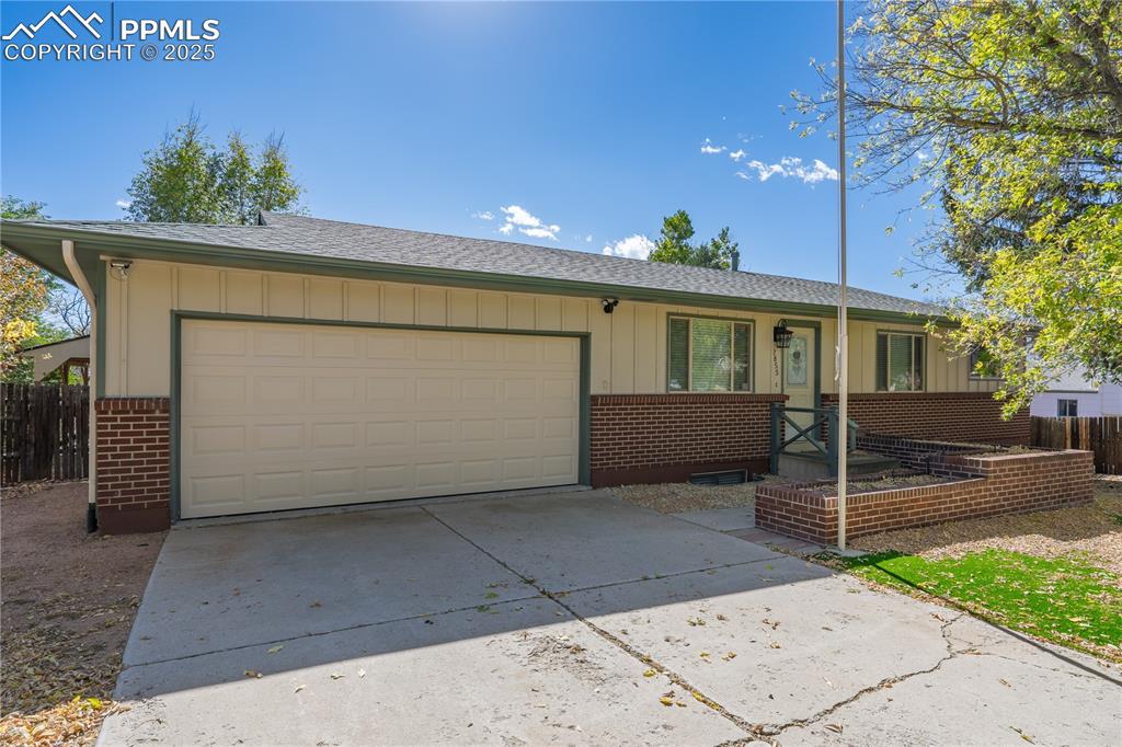 Image 2 of 35: Ranch-style home featuring board and batten siding, brick siding, a shingle