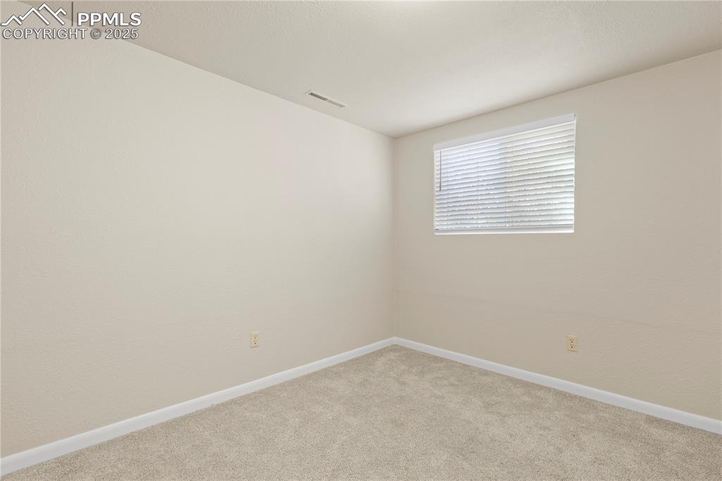 Image 24 of 35: Carpeted spare room featuring baseboards