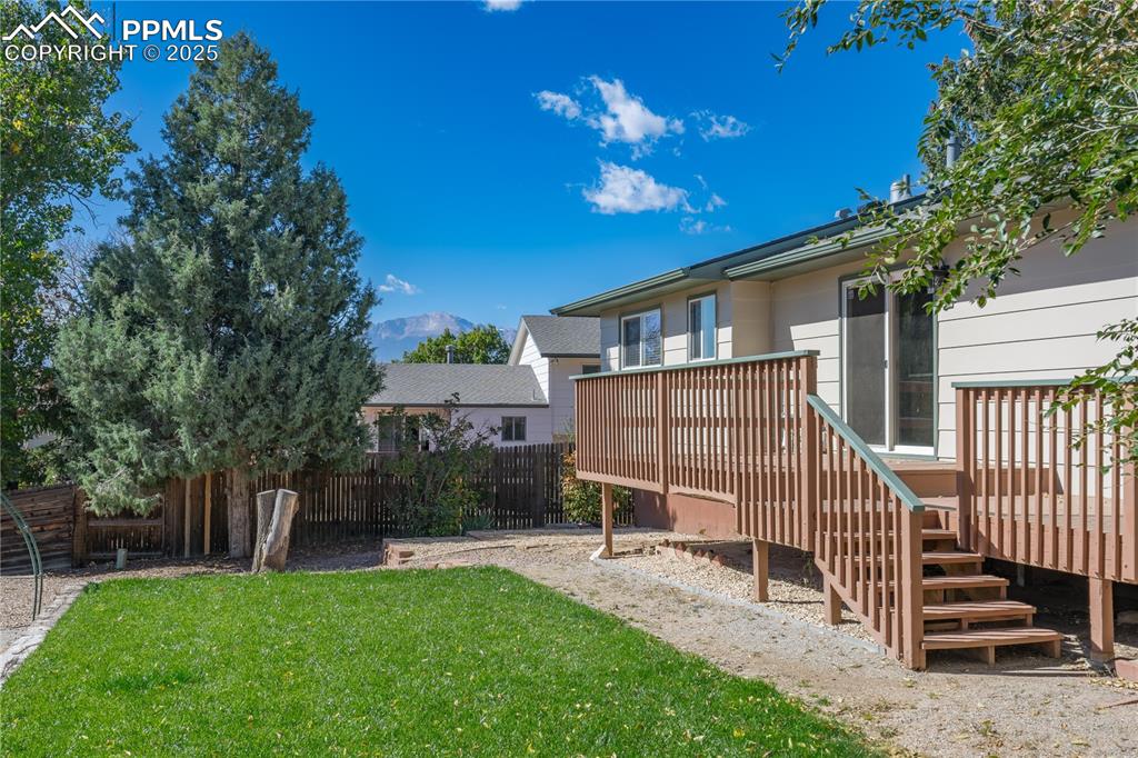 Image 29 of 35: View of yard featuring a deck with mountain view and stairs
